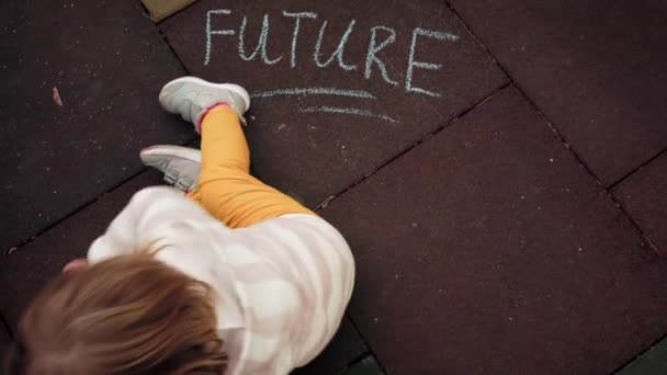 Little Girl Wrote Inscription Future Chalk Ground Top View Concept — Stock Video