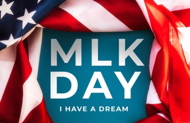 Blue background framed with American Flag and text abbreviation MLK. Happy Martin Luther King Day concept.