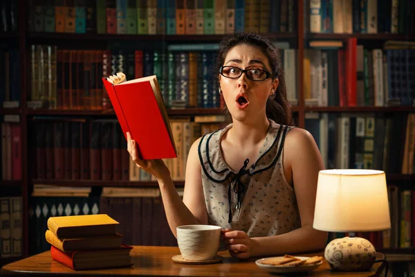 Quarantine Young Caucasian Woman Glasses Reads Book Surprise Holding Cup — Stockfoto