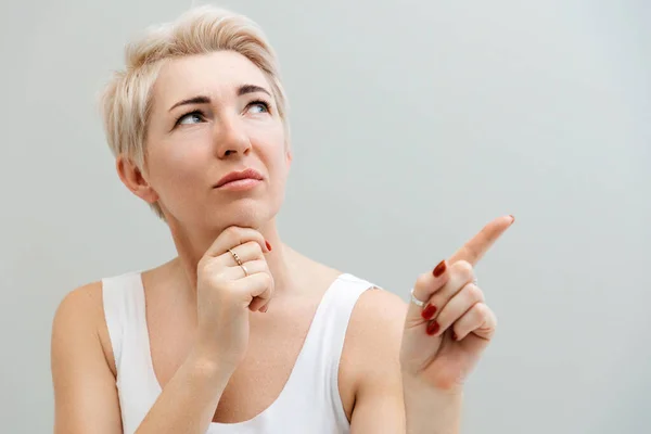 Portrait Thoughtful Adult Woman Pointing Her Finger Space Copy Space — Stockfoto