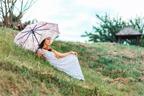 Summertime Young Woman Straw Hat Dress Holding Umbrella Lying Grass — Stockfoto