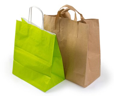 Düz kağıt saplı açık kahverengi kraft kağıdından ve beyaz arka planda ip saplı yeşil kağıt torbalardan yapılmış bir paket çantası.