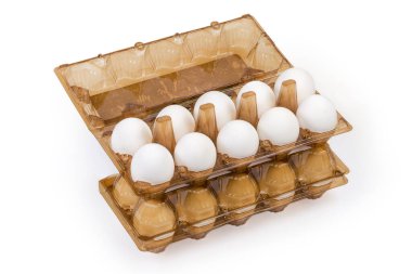 Chicken eggs in two brown plastic transparent disposable egg packaging trays on a white background