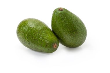 Two whole pear-shaped avocado fruits with green skin on a white background