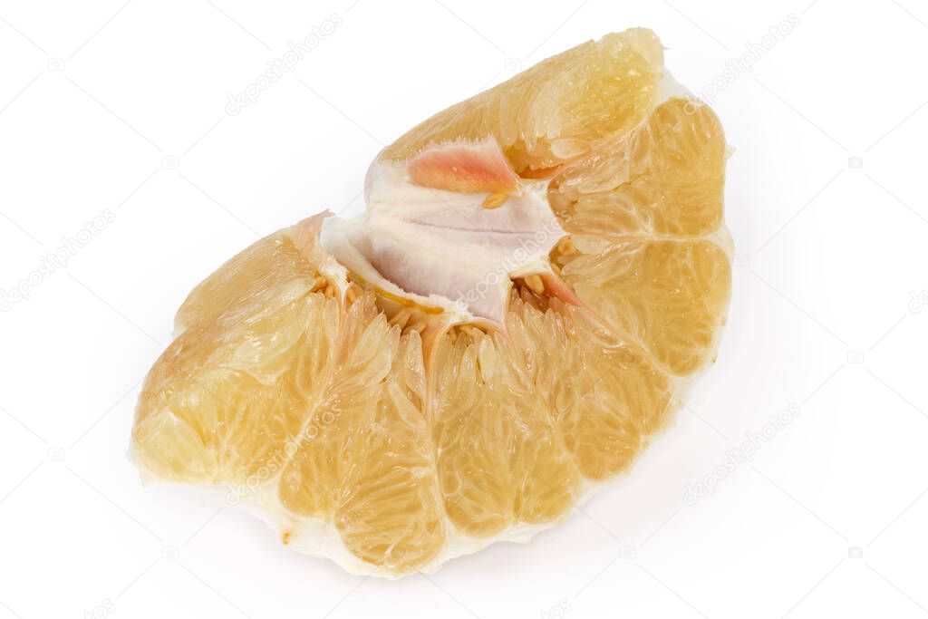 Peeled piece of a ripe pomelo fruit on a white background