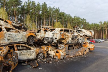Heap of the remains of the civil cars which was shot up and burned out by Russian soldiers during evacuation of unarmed peoples from war zone in Russian invasion of Ukraine, car graveyard, 2022