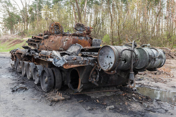 Russian battle tank which was destroyed on the roadside of highway during hostilities in Russian invasion of Ukraine, 2022, back view