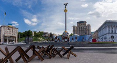 KYIV, UKRAINE - May 13, 2022: Maidan Nezalezhnosti with anti-tank hedgehogs removed from the road onto the sidewalk on a foreground during Russian invasion clipart