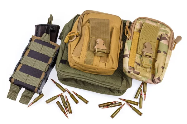 Boşaltma yeleği ya da kurşun geçirmez yelek, cepte şarjör ve beyaz arka planda saçılmış fişeklerle savaşmak için farklı askeri taktik keseler.