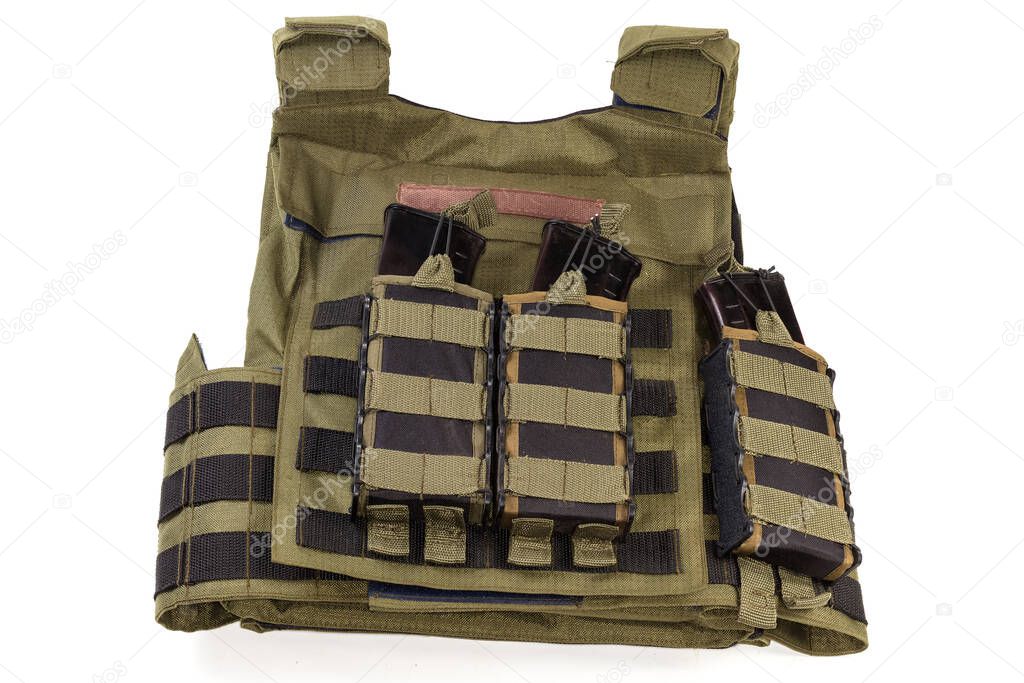 Military bulletproof vest with metal ballistic plate inserts, with fastened tactical pouches with cartridge rifle magazines on a white background