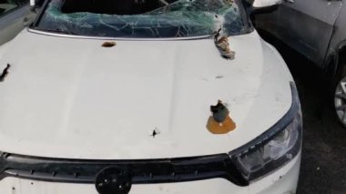 Irpin, Ukraine - April 27, 2022: Front of the civil car which was shot up by Russian soldiers during evacuation of unarmed peoples from war zone in Russian invasion of Ukraine, car graveyard 