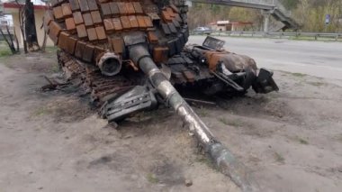 Kyiv bölgesi, Ukrayna - 29 Nisan 2022: Paslı Rus tankı Rusya 'nın Ukrayna' yı işgalinde bir otoyol kenarında imha edildi. Yıkılmış taret, namlu ağzı yere sıkışmış.. 