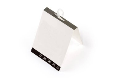 Blank white carton hanging tag with clothing care symbols on a plastic hanger on a white background