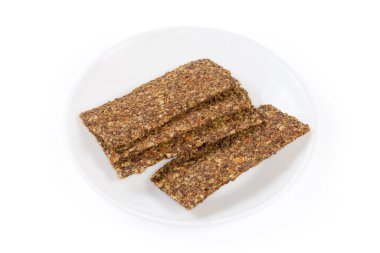 Flat crispbreads with vegetables, mushrooms and seeds on a saucer