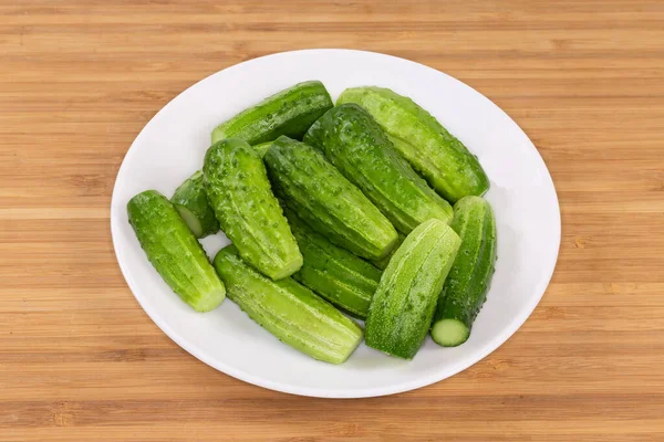 Whole Washed Small Young Cucumbers Cut Ends Dish Wooden Surface — Stok fotoğraf