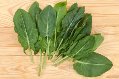 Freshly picked leaves of the garden sorrel on a rustic table, top view