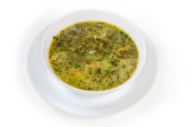 Sorrel soup, also known as green borscht in a white bowl on a white background
