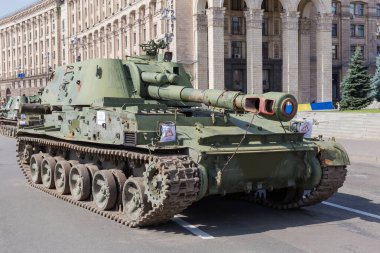 Kyiv, Ukraine - August 22, 2022: Exposition of Russian military equipment destroyed in Russian invasion of Ukraine, wrecked self-propelled howitzer on background of the administrative building