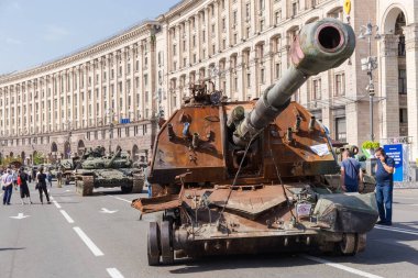 Kyiv, Ukraine - August 22, 2022: Exposition of Russian military equipment destroyed in Russian invasion of Ukraine, wrecked self-propelled howitzer and battle tank