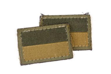 Two textile Ukrainian flag stickers in a camouflage drab and tan color scheme on an olive base with hook-and-loop fasteners close-up on a white background