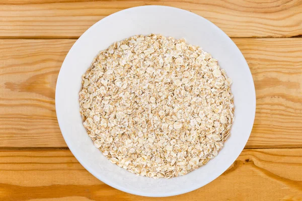 Raw Thin Rolled Oats White Bowl Rustic Table Top View — Stock Fotó