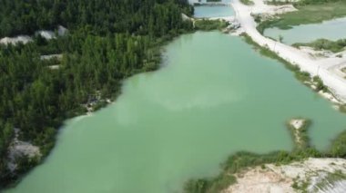 Quarry lakes in abandoned kaolin pit among forest, aerial view