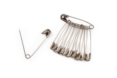 One open and several closed metal safety pins strung on the same single safety pin close-up on a white background