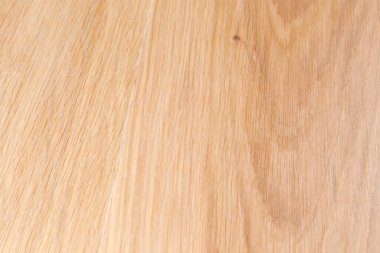 Wooden surface on the longitudinal cut of the light colored oak planks, view from an angle close-up in selective focus