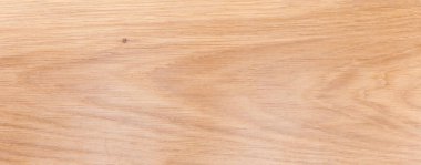 Texture of the wooden surface on the longitudinal cut of the light colored oak plank, top panoramic view close-up, background