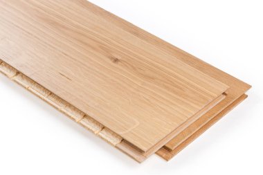 Three-layer engineered wood flooring boards with white oak face layer, pine core layer and glue-less locking joint system, fragment close-up on a white background 