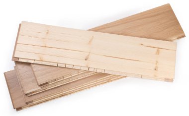 Stack of the three-layer engineered wood flooring boards with white oak face layer, pine core layer and glue-less locking joint system, top board turned face down on a white background
