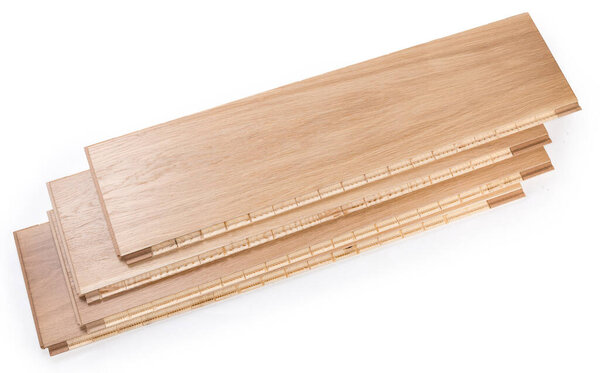 Stack of the three-layer engineered wood flooring boards with white oak face layer, pine core layer and glue-less locking joint system on a white background