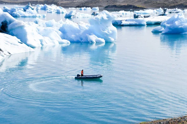 Man Driving Dinghy Some Glacier Icebergs Moving Sea Snow Capped — стоковое фото
