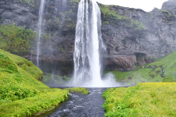 Enchanting waterfall making a very high jump from a rock slope - Concept of the Force of Nature