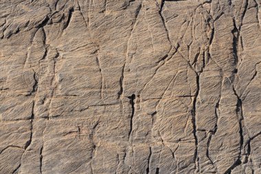 ABeautiful texture of natural gray and yellow granite stone surface with cracks in the photo