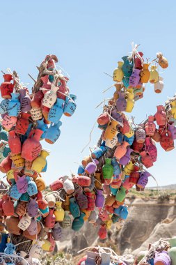 The Beautiful group of colored souvenir earthenware jugs with names on the blue sky background. Vertical