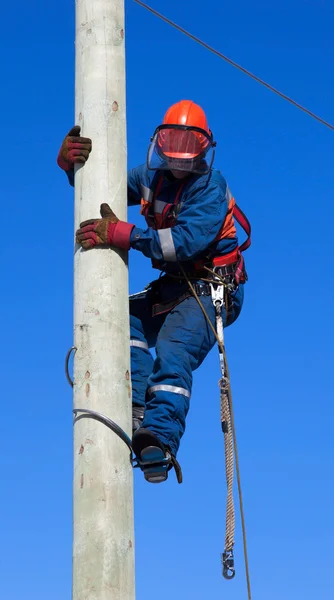 Electrician climbs the pole transmission line Telifsiz Stok Imajlar