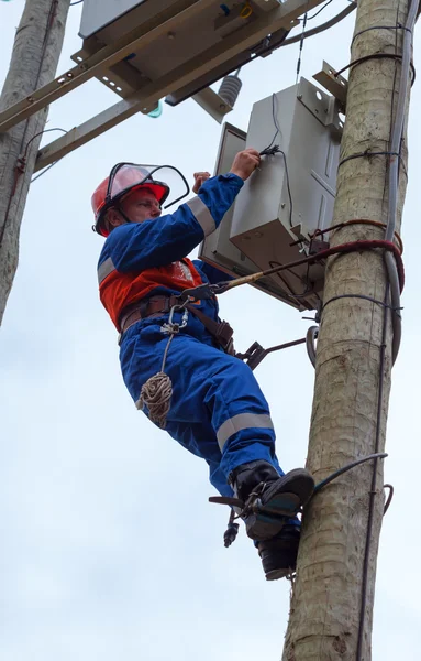 Eletricista realizar manutenção nas torres de transmissão reclo — Fotografia de Stock