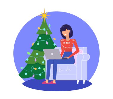 Noel ve yeni yıl tatilleri. Noel ağacının yanında dizüstü bilgisayarlı bir kadın oturuyor.. 
