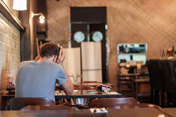 Homem sentado sozinho em um restaurante Imagens De Bancos De Imagens