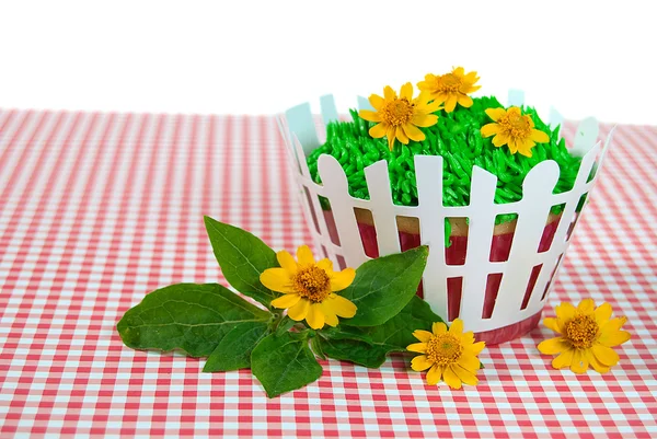 Flowers on grass icing — Stock Photo, Image