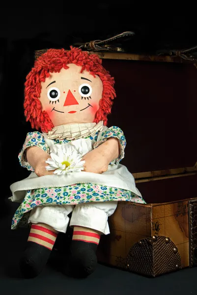 Old rag doll on a suitcase — Stock Photo, Image