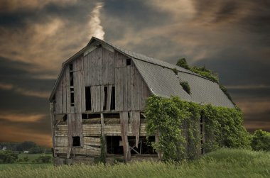 Old barn at sunset clipart