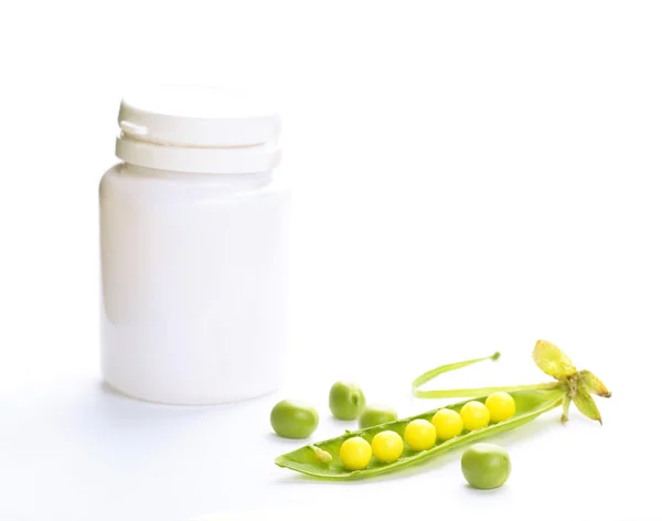 Peas and bottle with vitamin — Stock Photo, Image