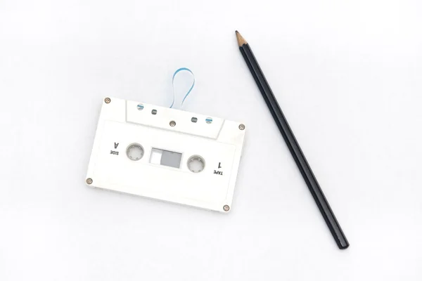 A pencil and an audio cassette tape — Stock Photo, Image