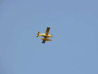 Güneşli gökyüzünde uçan su kayakları üzerindeki turbopervane uçaklar. Alt manzara. Bağımsız bir eyaletin sahilinde Sahil Güvenlik. Denizciler için hava desteği. Zor hava koşullarında iniş yapmak