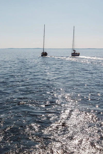 Glowing lagoon water in the midday sun, and yachts without sails in the distance. Quiet day, no wind