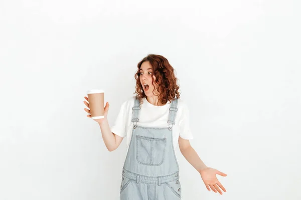 Young Woman Overalls Holding Hot Cup Coffee White Wall Waitress — Stock Photo, Image