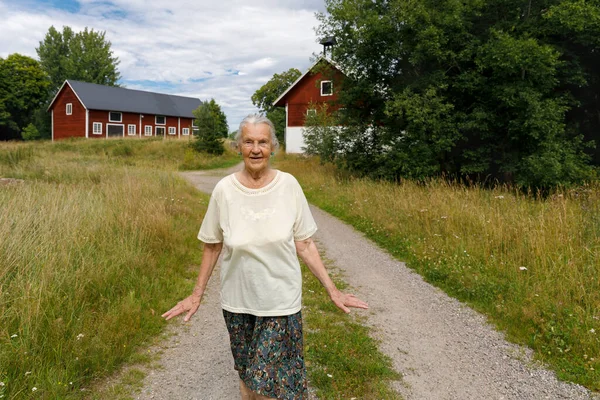 Senior Woman Walking Rural Road — Stock Photo, Image