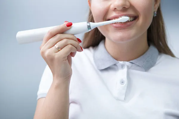 Обрезанный Снимок Женщины Стоматолога Показывающий Помощью Электрической Зубной Щетки — стоковое фото